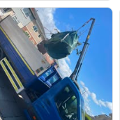 Crane lift loading waste onto the Clean Up Crew van
