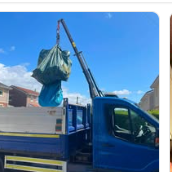 Crane truck lifting a loaded skip bag